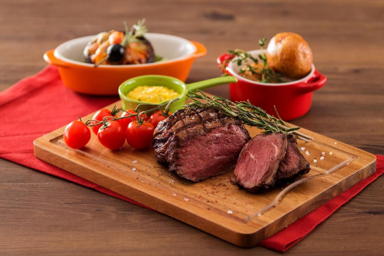 Hong Kong Gold Coast Hotel Dış mekan fotoğraf A steak prepared with the dry-aging technique